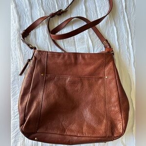 brown leather shoulder bag American Leather Co., featuring an adjustable strap.